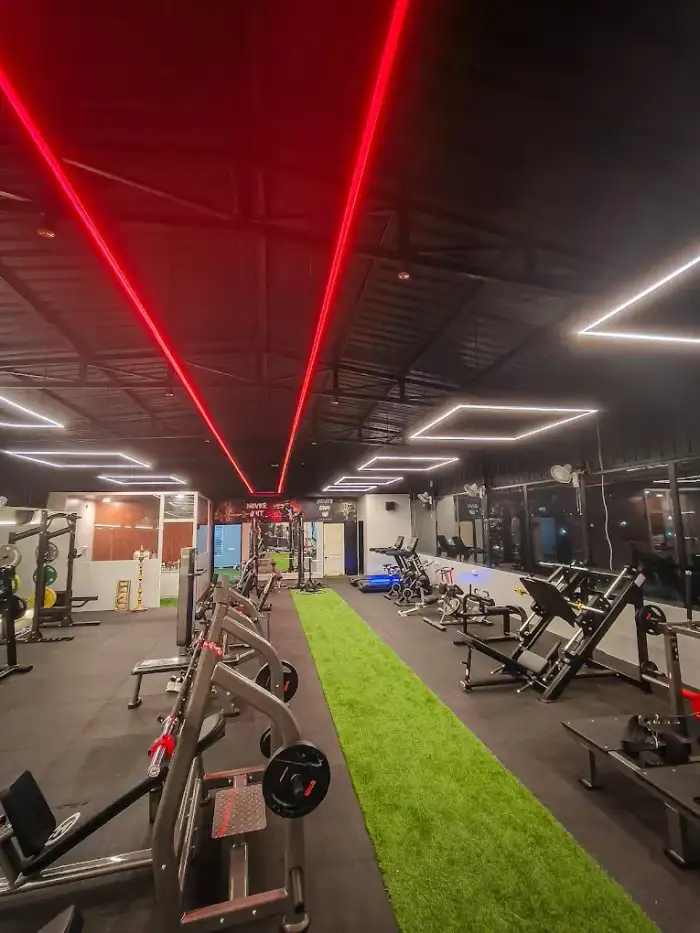 Training floor with red LED lighting and turf strip at JP Fitness gym in Kalapatti, Coimbatore